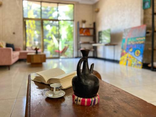 a black cat statue sitting on a table with a book at Mad Vervet Backpackers Hostel in Addis Ababa