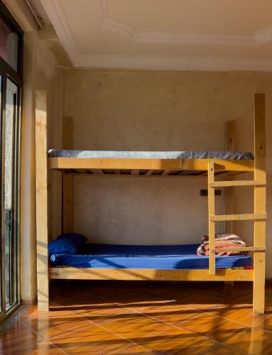 a bedroom with two bunk beds in a room at Mad Vervet Backpackers Hostel in Addis Ababa