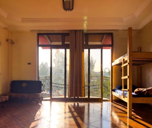 a bedroom with bunk beds and a balcony at Mad Vervet Backpackers Hostel in Addis Ababa