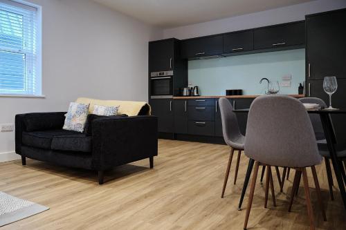 a living room with a couch and a kitchen at 7 Cannon Street in Preston