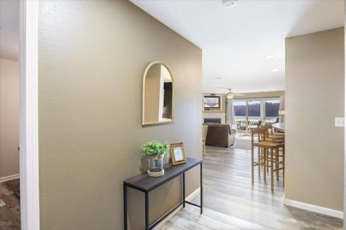 a living room with a table with a vase of flowers at Condo at Parkview Bay - Your Lakefront Oasis in Osage Beach