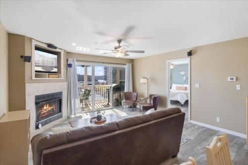 a living room with a couch and a fireplace at Condo at Parkview Bay - Your Lakefront Oasis in Osage Beach