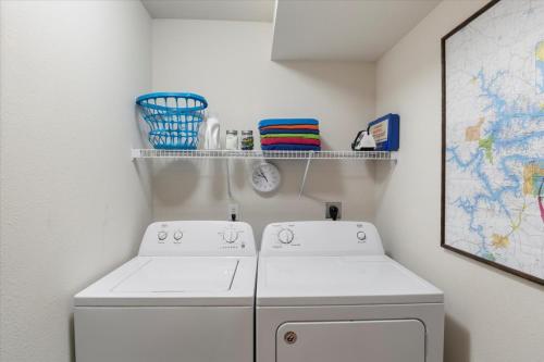 a laundry room with a washing machine and a shelf at Condo at Parkview Bay - Your Lakefront Oasis in Osage Beach