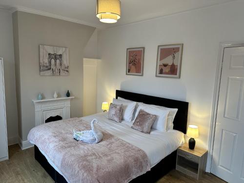 a bedroom with a bed with a swan on it at Luxury Stays in Birkenhead