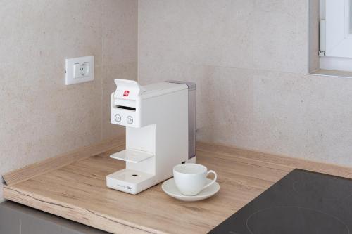 a coffee machine sitting on a counter with a cup at Epetium Beach Villa in Split