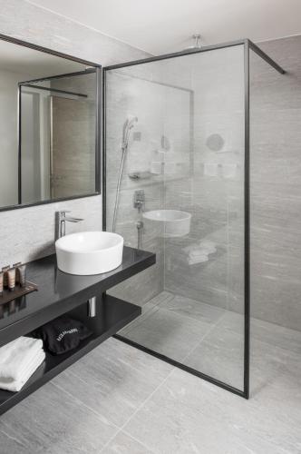 a bathroom with a glass shower and a sink at briig boutique hotel in Split