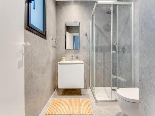 a bathroom with a shower and a sink and a toilet at Sanders Cruise-Spacious 2-bdr apt w2 balconies in Limassol