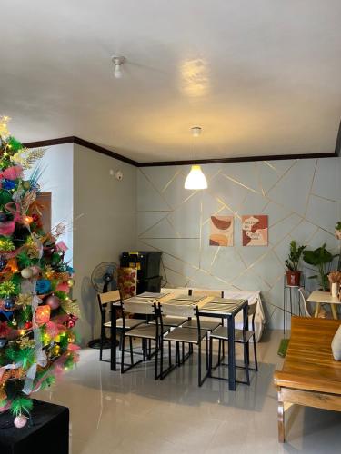 a dining room with a table and a christmas tree at Angel's Place Transient House in Tagbilaran City