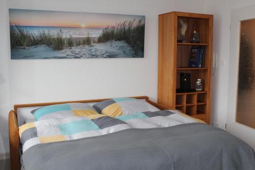 a bedroom with a bed with a picture on the wall at Urlaub im Herzen von Laboe in Laboe