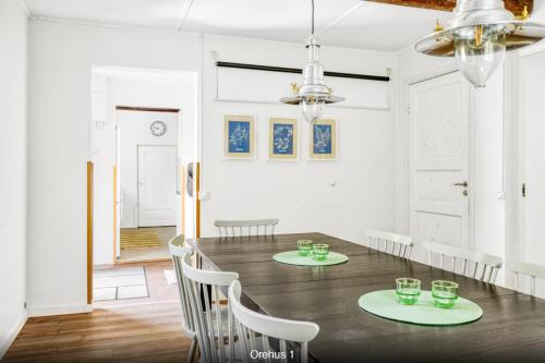 a dining room with a table and chairs at Orehus - Country side cottage with garden in Sjöbo