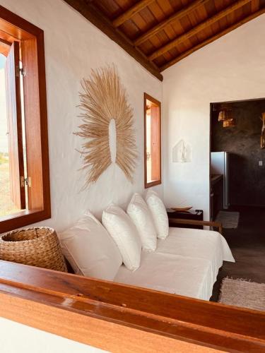 a bedroom with a bed with white sheets and pillows at Casa.mar Casa Hotel in Barra Grande