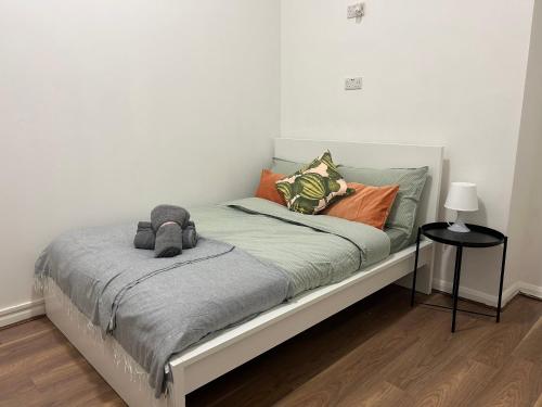 a bed with pillows on it in a room at Onefam Waterloo 18-36 years old in London
