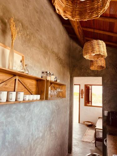 a kitchen with a counter with some cups on it at Casa.mar Casa Hotel in Barra Grande
