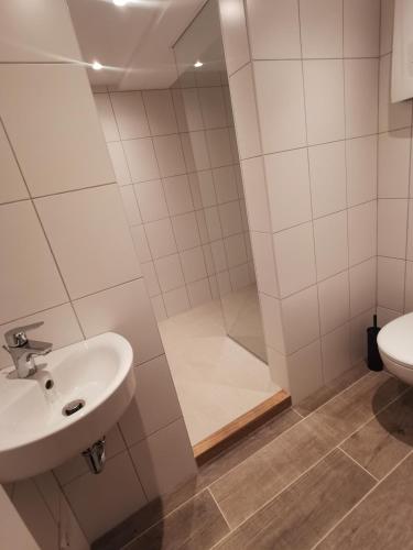 a bathroom with a shower and a sink and a toilet at Monteurzimmer / Apartment im Souterrain Berlin Neukölln in Berlin