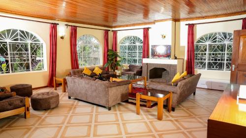 a living room with couches and a fireplace at Naivasha TownHouse in Naivasha