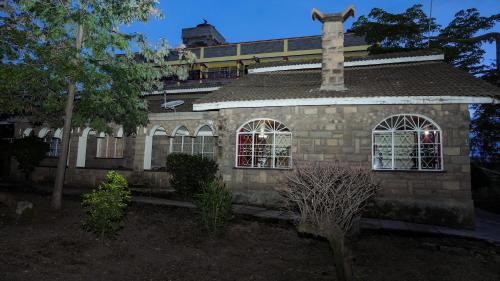 a stone house with a chimney on top of it at Naivasha TownHouse in Naivasha