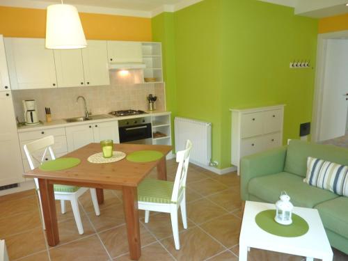 a kitchen and living room with a table and a couch at Appartamenti Girasole in Cannobio