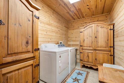 a white washer and dryer in a wooden bathroom at Lone Star w/ gametable in Ridgedale