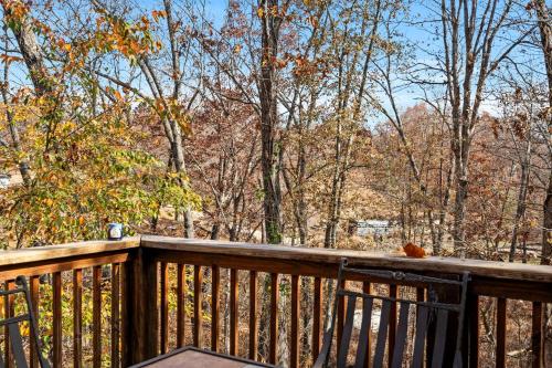 a wooden deck with a view of the woods at Lone Star w/ gametable in Ridgedale