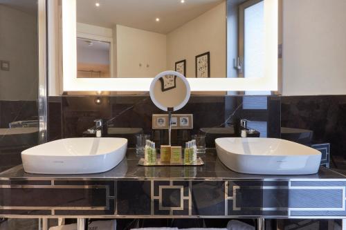 a bathroom with two sinks and a mirror at DoubleTree By Hilton A Coruña in A Coruña