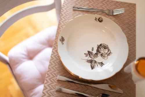 a plate with a flower on it on a table at Apartment in Vrbnik/Insel Krk 13613 in Vrbnik