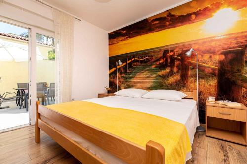 a bedroom with a large painting on the wall at Apartment in Vrbnik/Insel Krk 13610 in Vrbnik