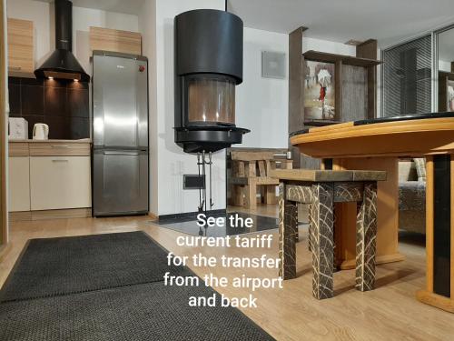 a kitchen with a refrigerator and a counter top at Champêtre Park View Apartments in Rīga