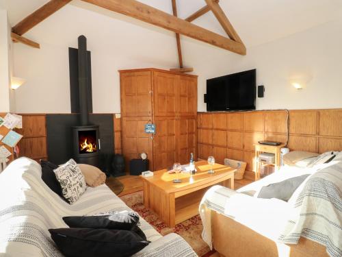 a living room with two couches and a fireplace at Grace's Retreat in Darlington