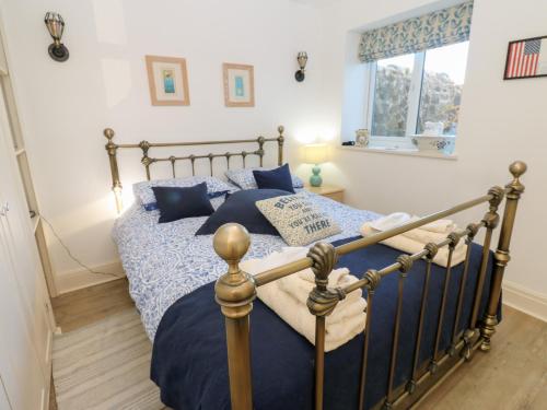 a bedroom with a bed with blue sheets and a window at Grace's Retreat in Darlington