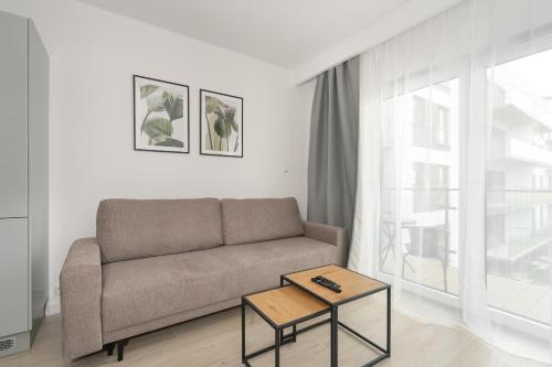 sala de estar con sofá y mesa en Tasteful Beige Apartment with Parking by Renters en Poznan