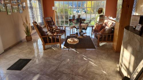 a living room with chairs and a table at Hotel Lago del Desierto in El Chalten