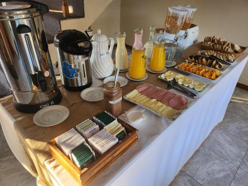 a table with a bunch of food on it at Hotel Lago del Desierto in El Chalten