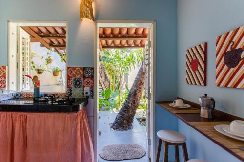 a kitchen with an open door to a patio at Vila Charme in Jericoacoara