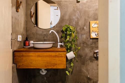 a bathroom with a sink and a mirror at Vila Charme in Jericoacoara