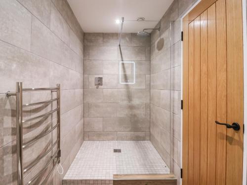 a bathroom with a shower with a glass door at Robins Nest in York