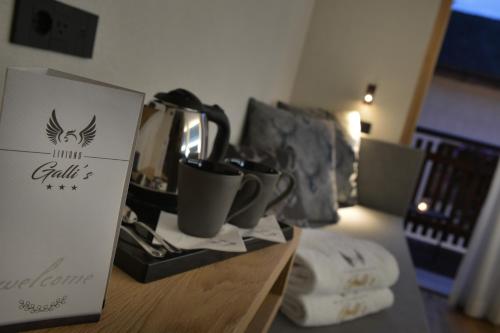 a table with cups and a box on it at Hotel Galli's - Centro in Livigno