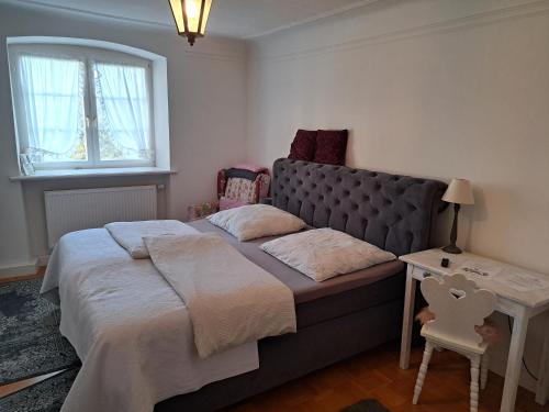 a bedroom with a large bed and a window at s'Himmelreich in Leutkirch im Allgäu