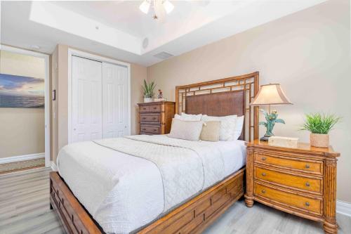 a bedroom with a large bed and a dresser at Villa Vista Mare - 675 in Siesta Key