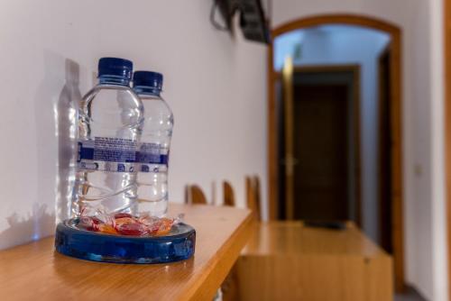 two bottles of water sitting on top of a table at Hostal Montserrat in Montseny