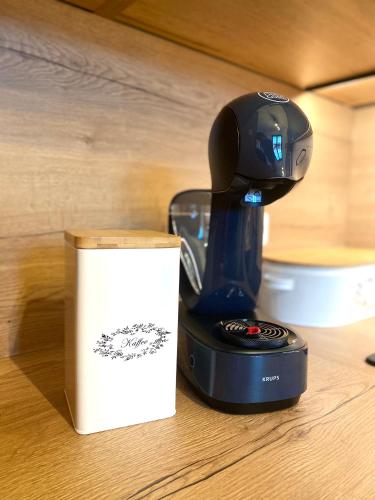 a coffee maker sitting on a table next to a box at Apartmán v Kašperských Horách in Kašperské Hory