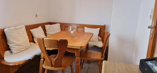 a dining room table with a glass of wine on it at Nomadengold in Ottobrunn
