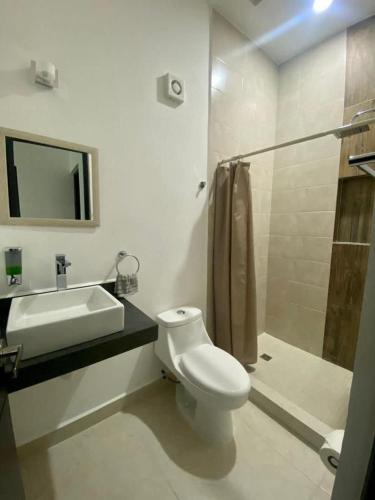 a bathroom with a toilet and a sink and a shower at Casa de lujo en Playa del Carmen in Playa del Carmen