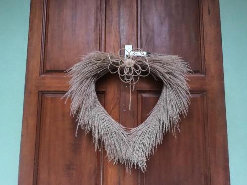 a wreath is hanging on a door at Nhà Lúa Homestay in Ninh Binh