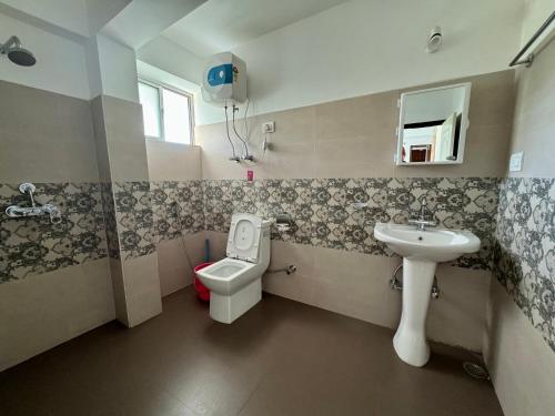 a small bathroom with a toilet and a sink at Darjeeling Hillside Inn in Darjeeling