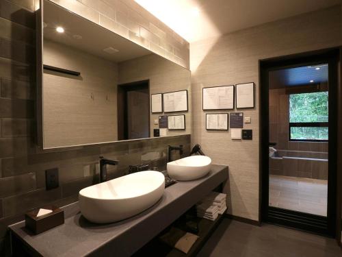 a bathroom with two sinks and a mirror at Rakuten STAY VILLA Nikko in Nikko