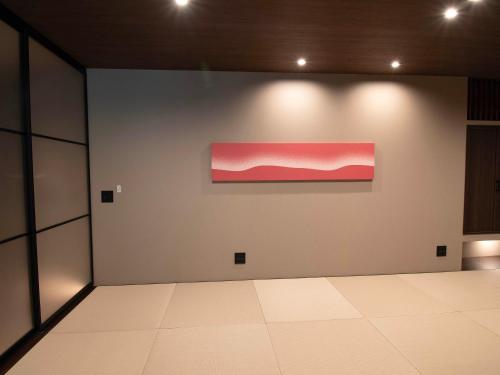 a room with a pink painting on a wall at Rakuten STAY VILLA Nikko in Nikko