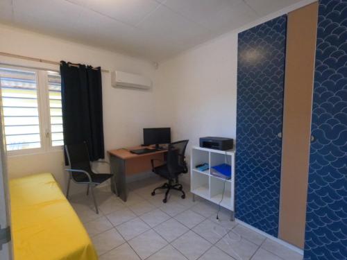 an office with a desk and a computer in a room at Finisterre Curaçao in Sabana Westpunt