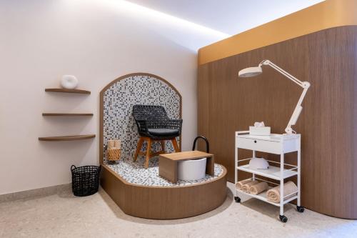 a room with a chair and a desk with a lamp at Bali Star Resort Hotel in Balíon
