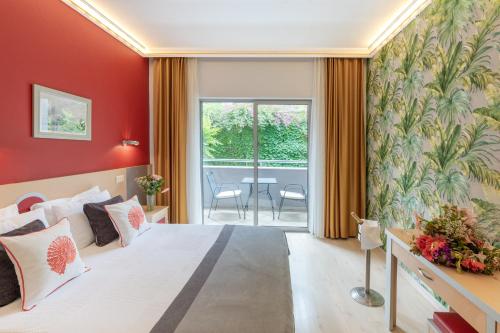 a bedroom with a large bed with red walls at Grand Viking Hotel in Kemer