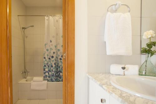 a white bathroom with a sink and a shower at Apartamento Estándar 1 in Colonia Sant Jordi